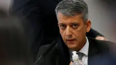Dias com olhar sério enquanto escuta senador na CPI