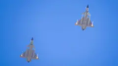 Two J-16 air fighters fly over a training base of PLA's naval aviation force in Ningbo in east China's Zhejiang province