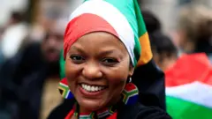 Woman wearing South Africa flag headscarf and earrings