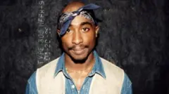 Rapper Tupac Shakur poses for photos backstage after his performance at the Regal Theater in Chicago in March 1994.