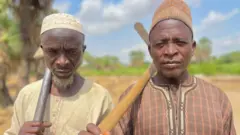 Abdulaziz and Abdulwahid with dia grave digging tools