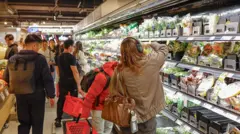 Shoppers seen browsing at a supermarket. 