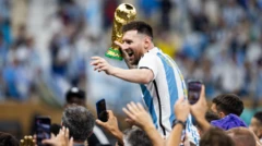 Lionel Messi celebrates with the 2022 World Cup trophy