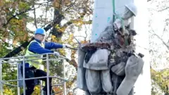 Man destroying monument in Poland