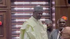 Former AGF wear cream colour cloth wit cap