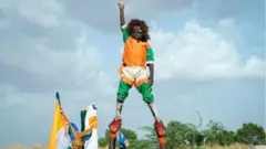 A boy supporting Niger coup stands on someone's hands