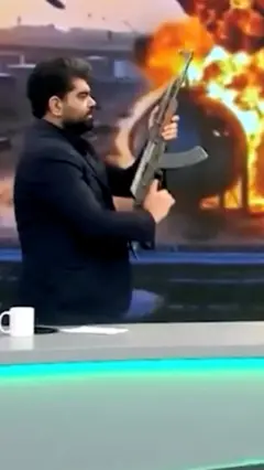 Eron TV boshlovchisi Kalashnikov avtomati bilan