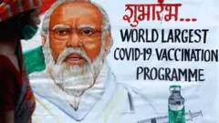 Man walking past a poster of PM Modi in Mumbai