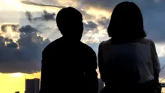 A couple enjoys the sunset in Odaiba, Tokyo.