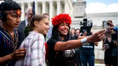 Climate activist Greta Thunberg poses for a selfie with Panamanian climate activist Militza Flaco outside the US Supreme Court in Washington DC, USA. 18 September 2019