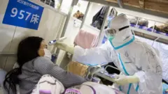 Health worker dey check coronavirus patient