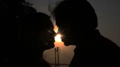 Couples to celebrate Valentine's Day in front of River Ganges in Kolkata,India, Tuesday, Feb. 14, 2023.