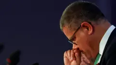 The COP26 president apologised as a late amendment on coal was added to the draft text.