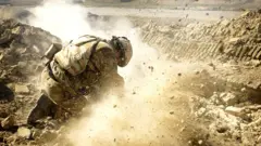 British soldier firing light mortars in to an Afghan village, January 2007