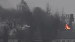 Fire is seen coming out of a military installation near the airport, after Russian President Vladimir Putin authorized a military operation in eastern Ukraine, in Mariupol, February 24, 2022.