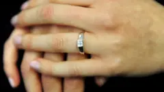 An engagement ring worn on a finger