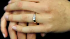 An engagement ring worn on a finger
