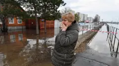 Woman in flooded area of Orenburg city