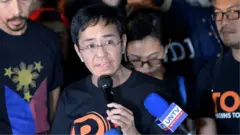 Maria Ressa (C), the CEO and editor of online portal Rappler, speaks during a protest on press freedom