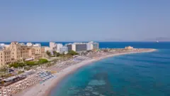 Image shows a beach in Rhodes