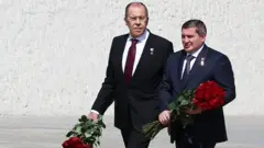 Лавров и губернатор Андрей Бочаров (слева направо) на церемонии возложения цветов на территории историко-мемориального комплекса на Мамаевом кургане в честь окончания Второй мировой войны