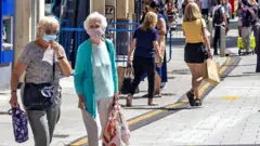 A view of Queen Street filled with shoppers