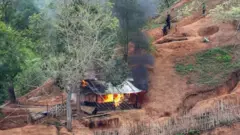 Ethnic minority Karen troops are seen after setting fire to a building inside a Myanmar army outpost near the Thai border, which is seen from the Thai side on the Thanlwin, also known as Salween, riverbank in Mae Hong Son province, Thailand, April 28, 2021