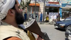 A Taliban fighter directing traffic in Kabul