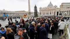 People queue to see the body of former Pope Benedict XVI at the Vatican