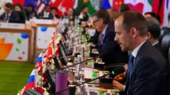 A Russian delegate sits at long table of G20 Finance Ministers and Central Bank Governors at meeting in Bengaluru, India