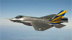 This image released by the US Navy courtesy of Lockheed Martin shows the the US Navy variant of the F-35 Joint Strike Fighter in flight