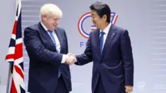 British Prime Minister Boris Johnson and Japanese Prime Minister Shinzo Abe shake hands during their bilateral meeting on the sidelines of the G7 Summit.