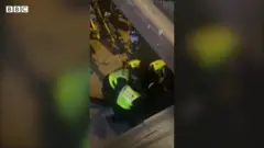Man being pulled away by police