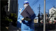Medical worker in protective suit, Shanghai, 4 April 2022