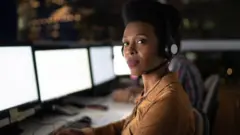 A customer service executive working in the night