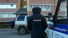 A policeman at the scene of the shooting in the village of Yelatma, Russia