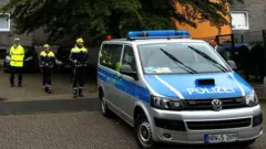 Police officers at a residential building where the bodies of five children were found in the western town of Solingen, Germany, 3 September 2020