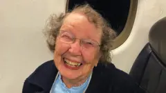 Elderly lady sitting on an aeroplane