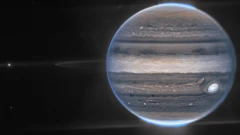 Webb NIRCam composite image from two filters – F212N (orange) and F335M (cyan) – of Jupiter system, unlabeled (top) and labeled (bottom).