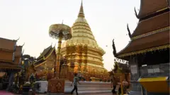 Devotees prepare large candles at Doi Suthep Buddhist temple in the northern Thai province of Chiang Mai