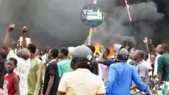 Supporters of the coup set fire to the ruling party HQ in Niamey, Niger - 27 July 2023