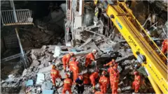 This photo taken on July 12, 2021 shows rescuers searching at the site of a hotel