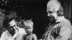 Black and white picture of Albert Einstein, his son Hans Albert, and his grandson Bernhard (1936).