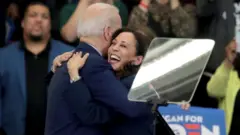 Mr Biden and Ms Harris at a campaign event
