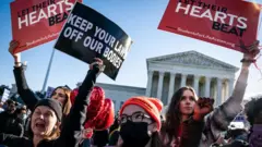 Pro-life and pro-choice protestors gather outside the Supreme Court as arguments begin about the Texas abortion law by the court on Capitol Hill on Monday, Nov. 01, 2021 in Washington, DC