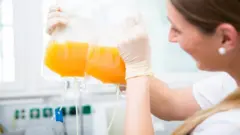 Nurse holding a plasma donation