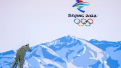 A worker makes repairs to a video wall at the Winter Olympics' Main Media Centre