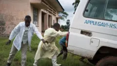 Mr Lwesso and his colleagues push a vehicle to get it started