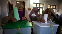 Two women cast their ballots in the parliamentary election on 18 February 2008 in Peshawar, Pakistan.
