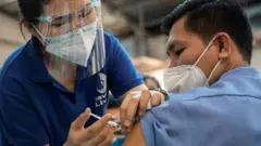 Health worker receives Pfizer booster shot in Quezon City, Philippines - November